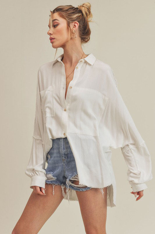 CHRISTIAN FASHION CLOTHING BRAND - ATALIE THE LORD IS EXALTED. The Phoebe Top is an essential button down. This forever classic style is slouchy, has an oversized fit and raw edge detailing that adds the perfect shape to any look. Our signature cross can be found on the right front pocket. 100% Cotton Imported